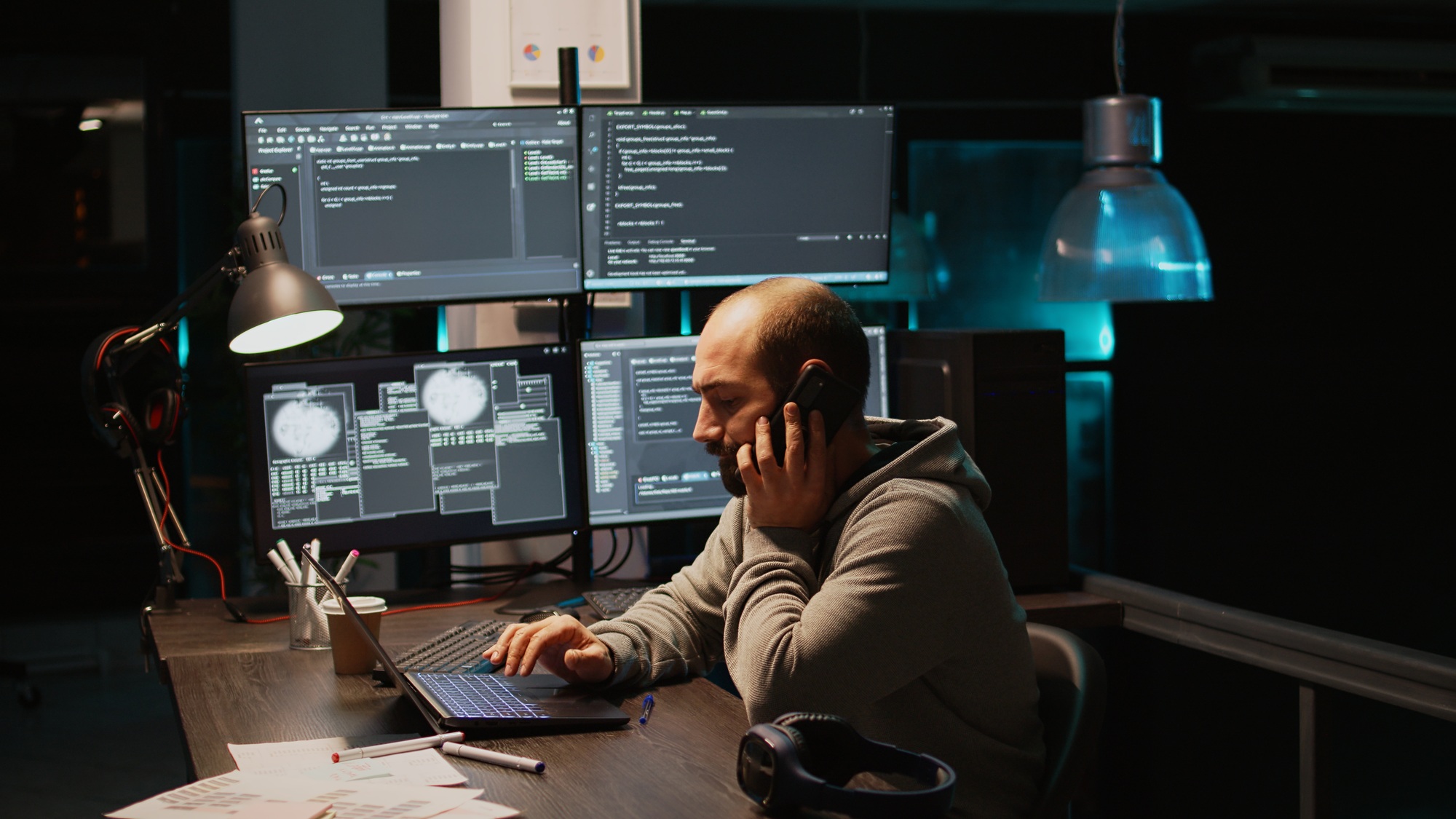 Web developer talking on phone call in programming office