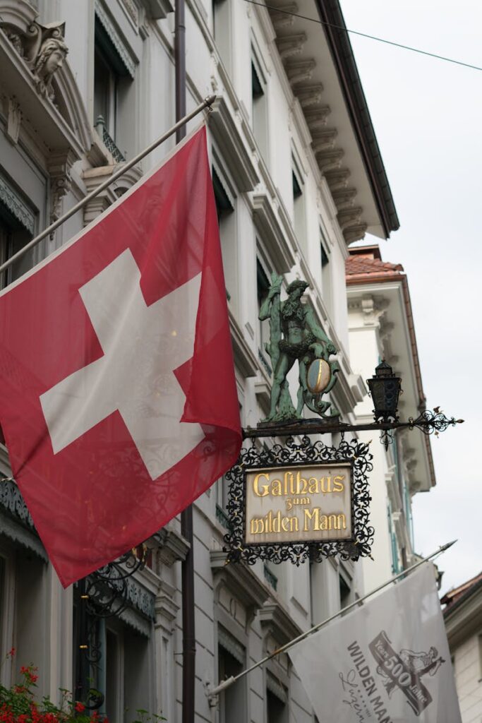 Swiss flag near historic Luzern gastropub sign, capturing cultural essence.