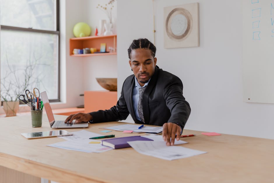 Product owner working with agile backlog on a laptop in a modern office