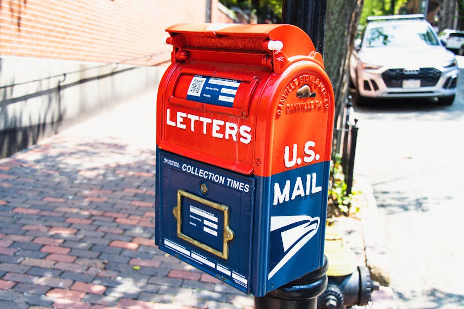 Hand placing a letter into a mailbox for registered mail