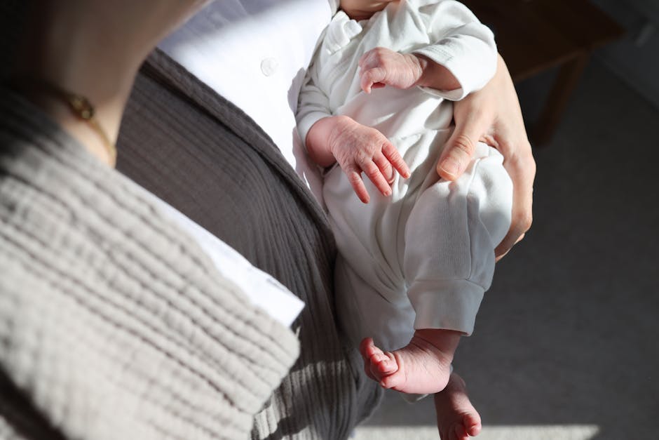 Parents with newborn baby at home reviewing family budget documents