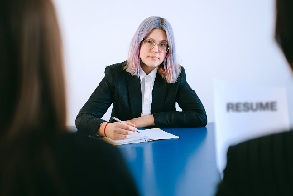 Recruitment professional reviewing a CV on a laptop