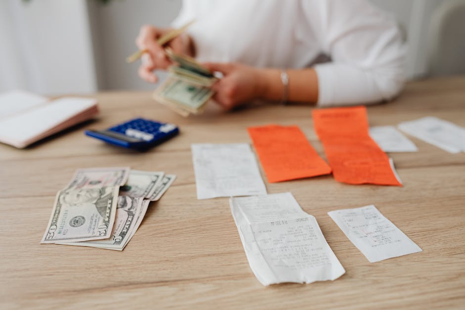 Worker reviewing payslip and household budget at home