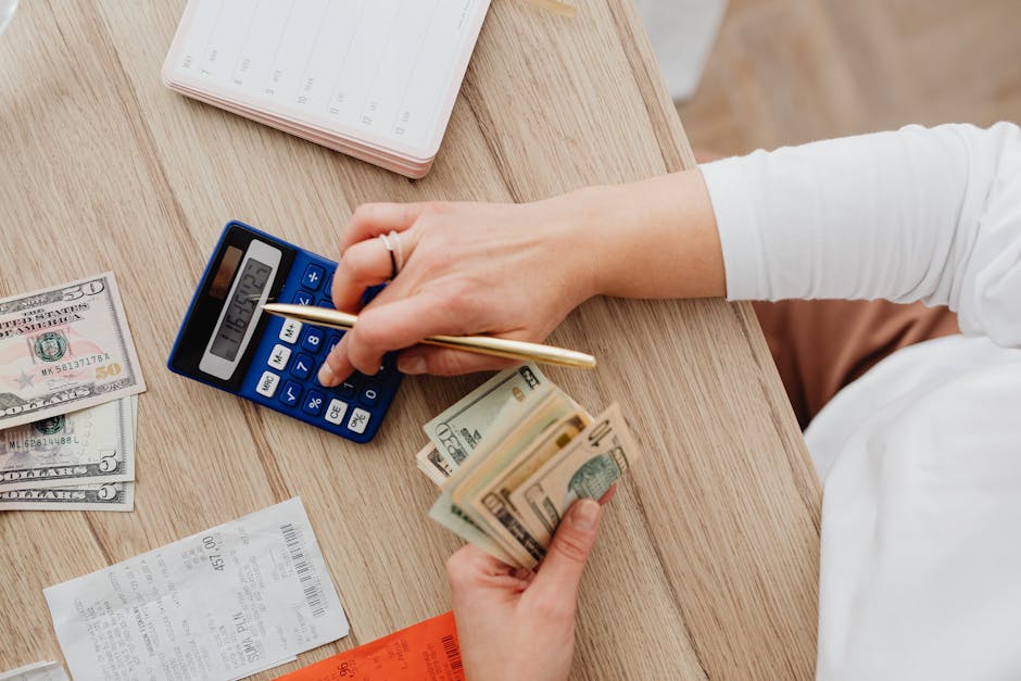 Family planning finances with calculator and baby items on a table