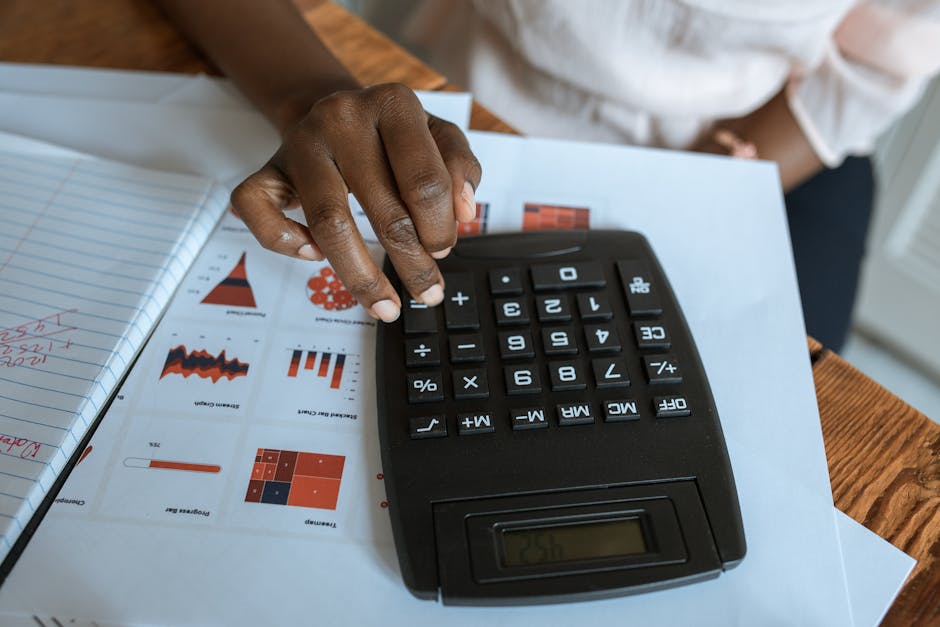 Calculator and salary figures on desk for compensation calculation