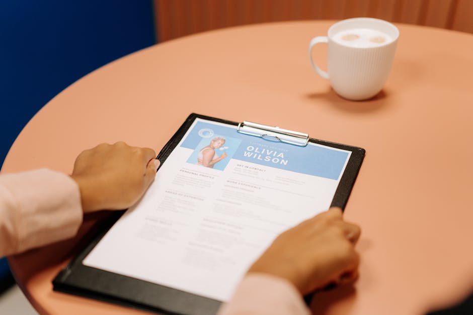 Hiring manager reviewing a stack of CVs and recommendation letters