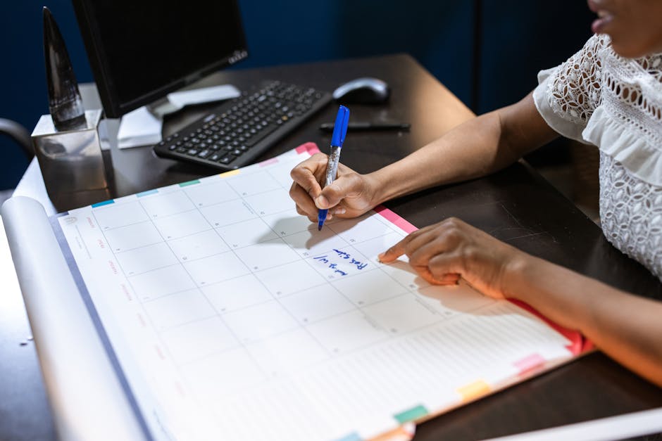 Focused professional organizing tasks on a calendar and laptop