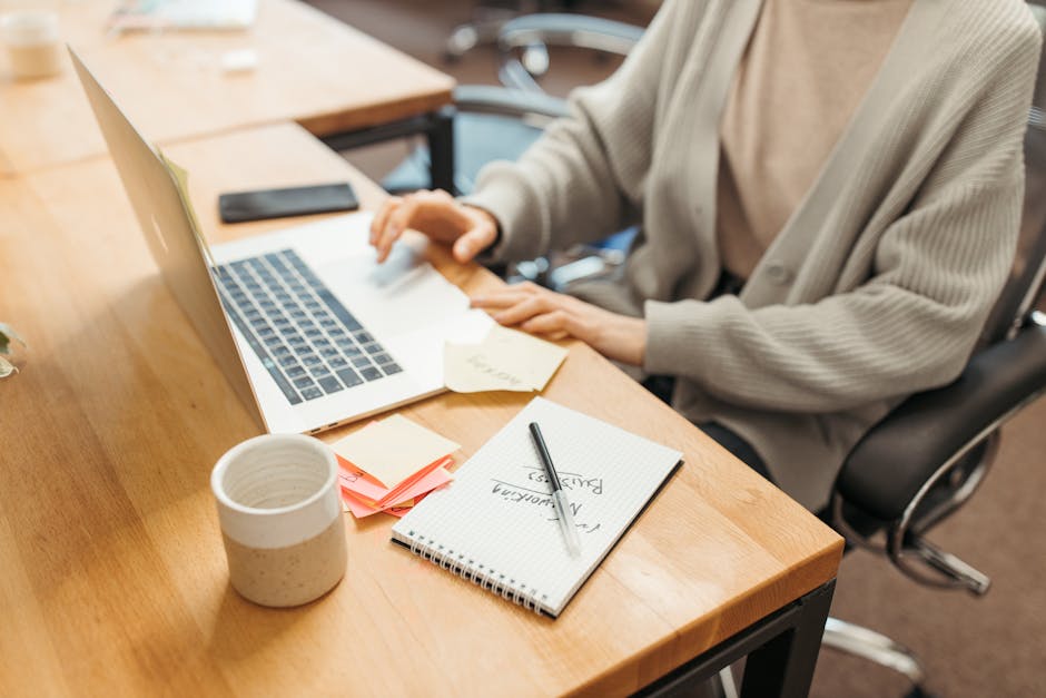 Candidate preparing for a job interview with notes and laptop