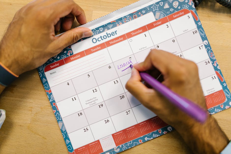 Person checking a wall calendar and planning time off
