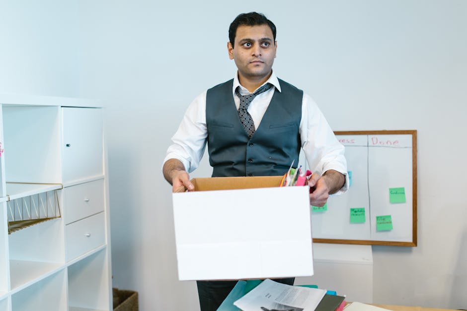 Employee leaving office desk with paperwork