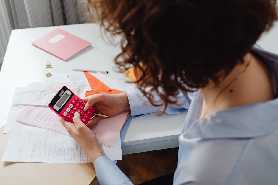 Family budgeting with calculator and paperwork on table