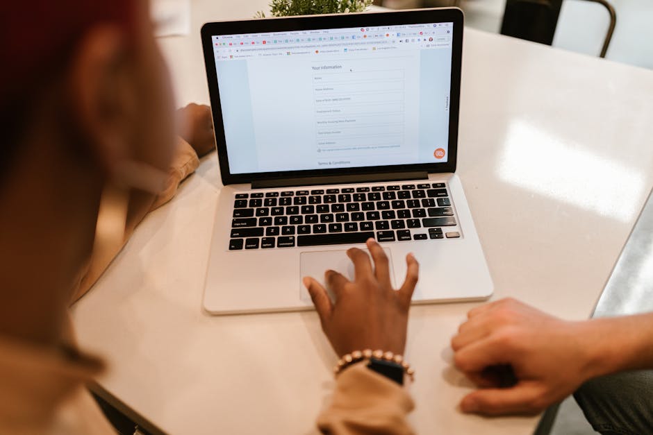 Person submitting an online social benefits application on a computer