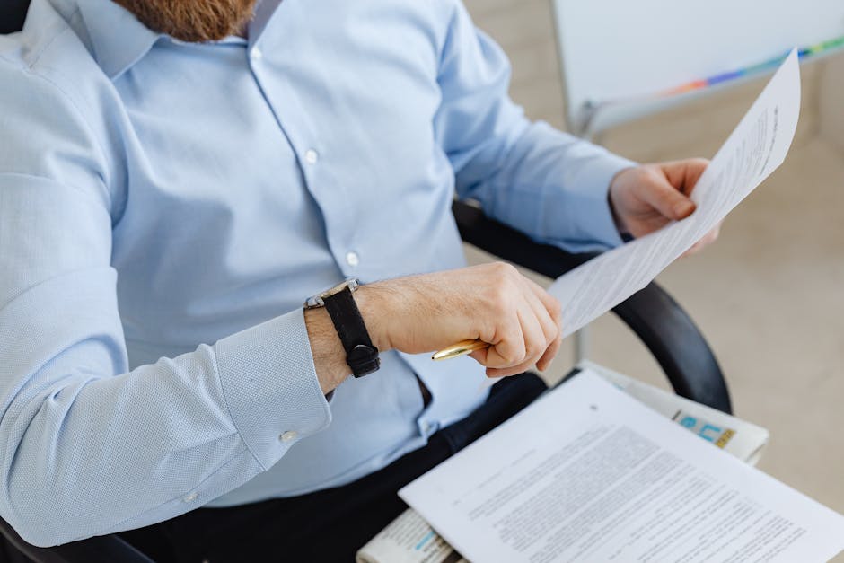 Person reviewing employment documents and payroll papers