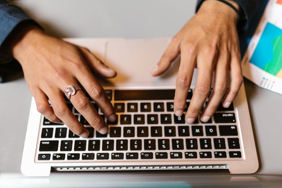 Business professional writing a concise motivational email on a laptop
