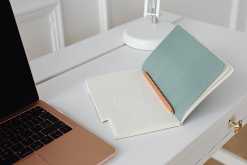 Person preparing interview notes with laptop and notebook