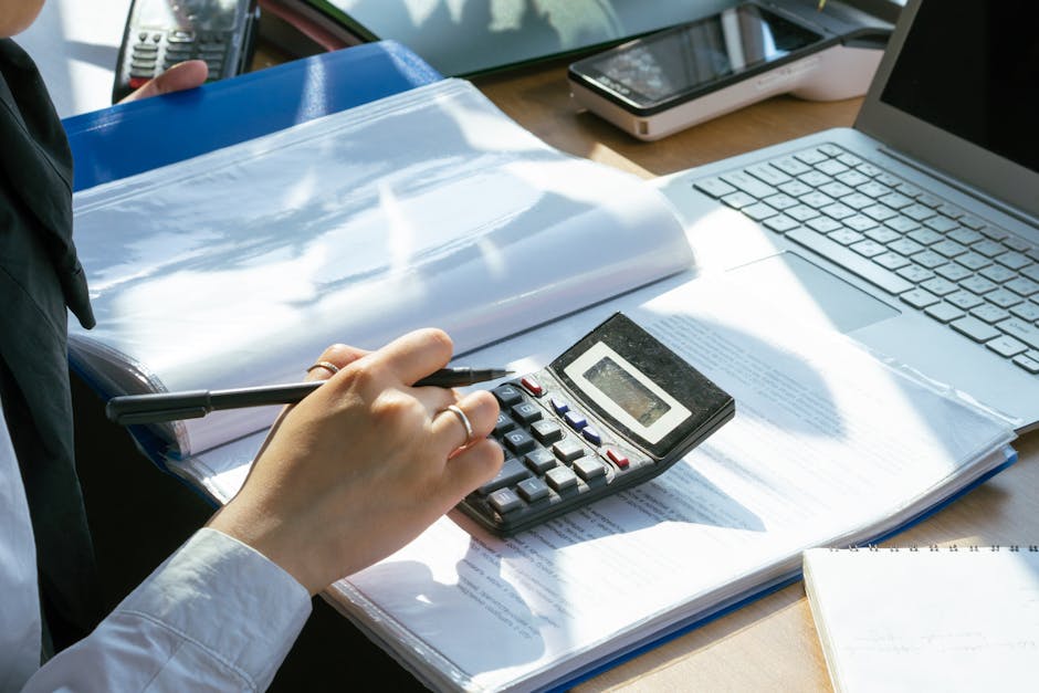 CAF benefits calculator on a laptop with financial documents