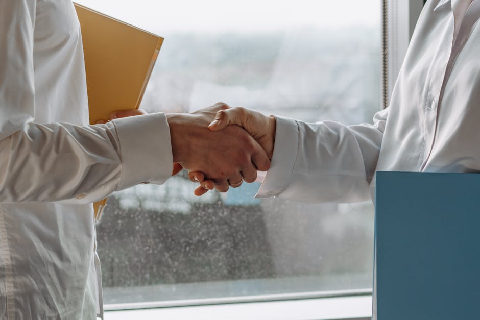 Professional networking handshake in a modern office