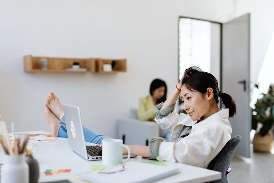Employee reviewing leave balance on a laptop at work