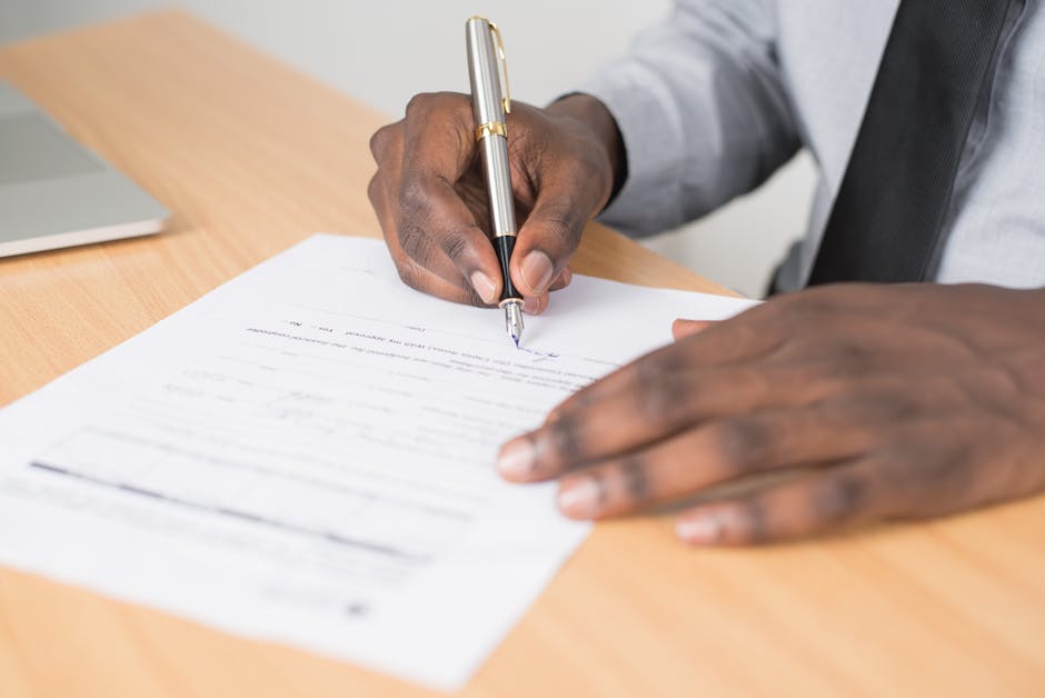 Business document with signature and contact details on a desk