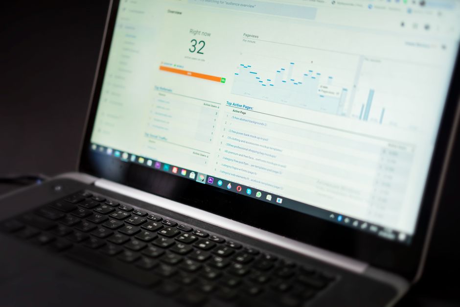 Professional manager analyzing operational performance dashboards on a laptop in an office