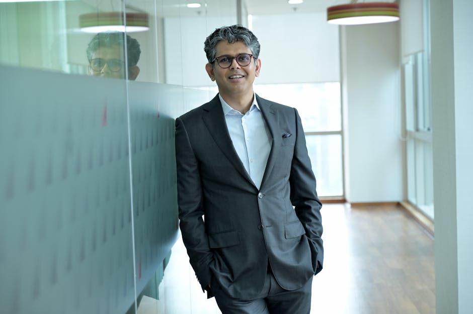 Confident executive walking in office corridor