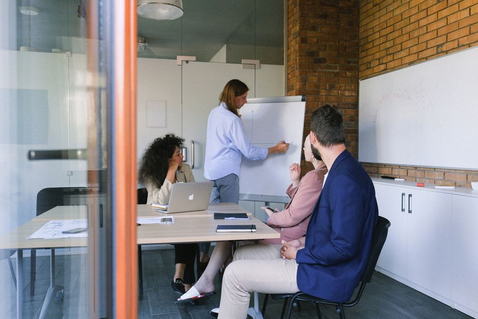 Corporate coaching and management team meeting in modern office