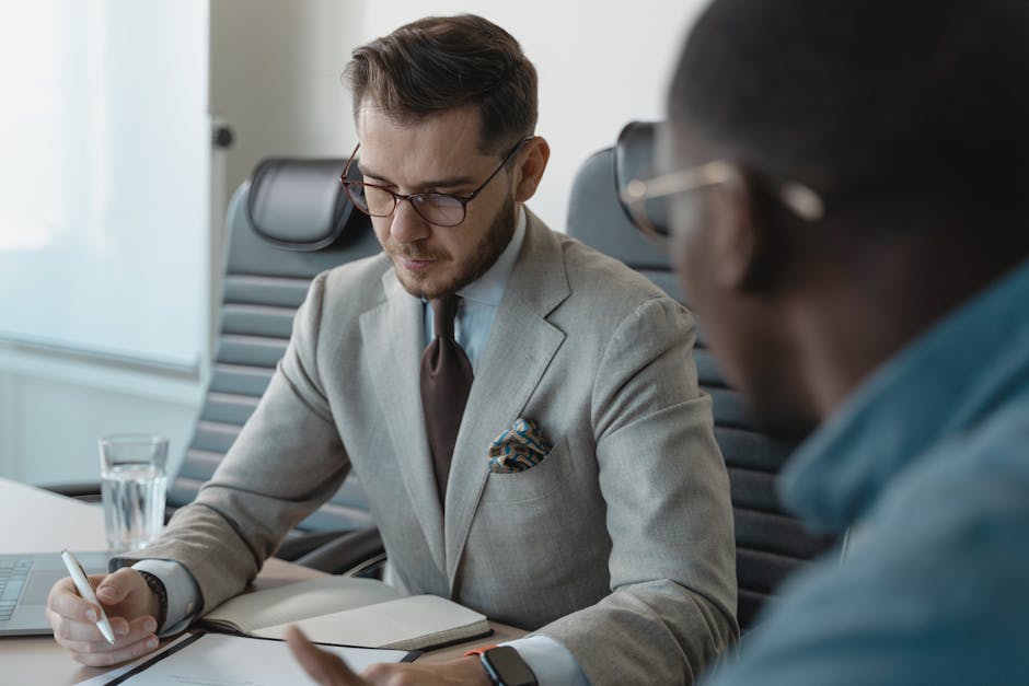 Professional receiving feedback in a meeting, illustrating recognition and esteem at work