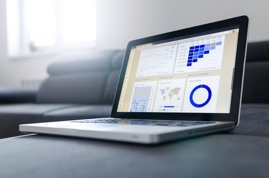 Business professional presenting performance metrics on a laptop screen