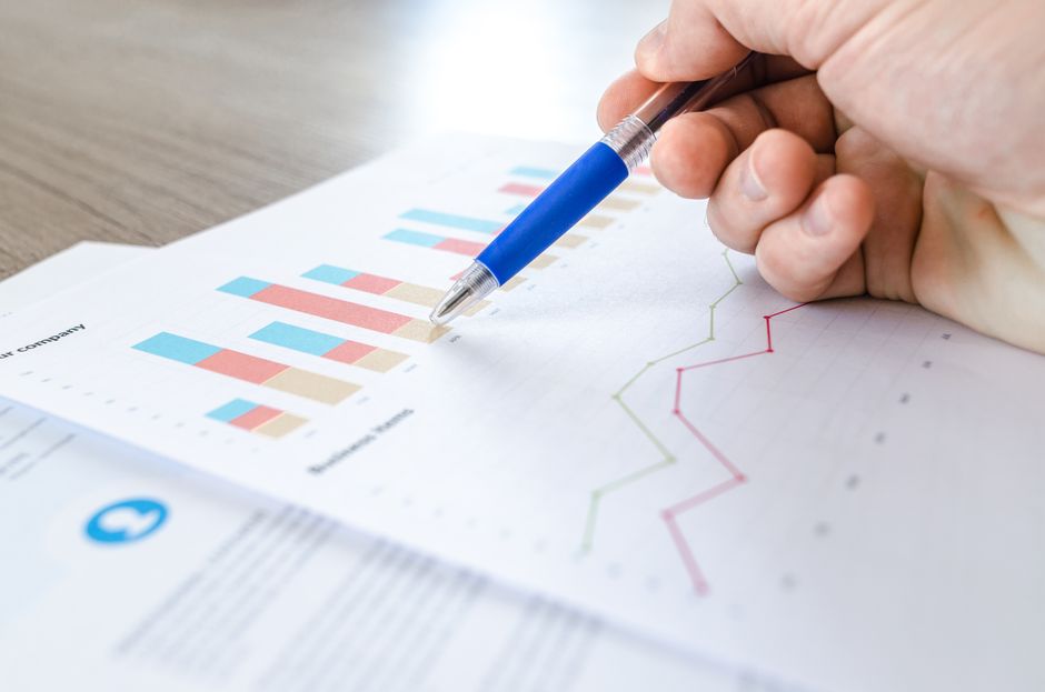 Corporate financial analysis with charts and paperwork for economic restructuring