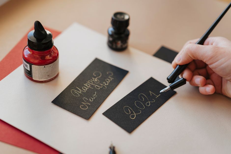 Handwritten greeting card on a desk with pen