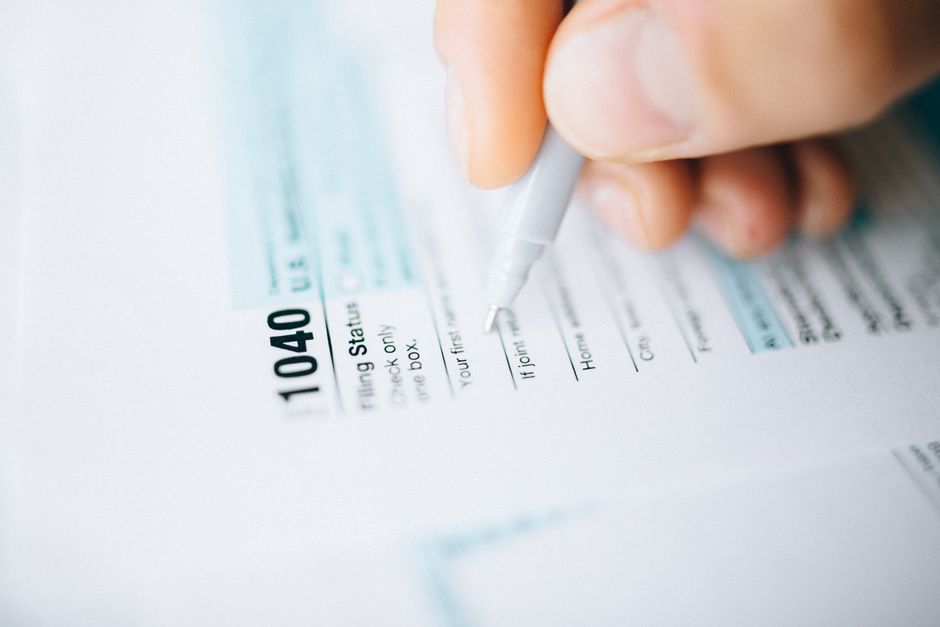 Person filling out an online tax return on a laptop