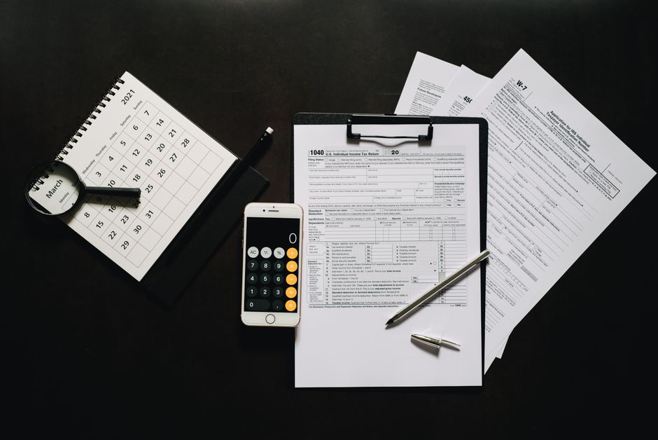 Business calculator and French payroll tax forms on desk