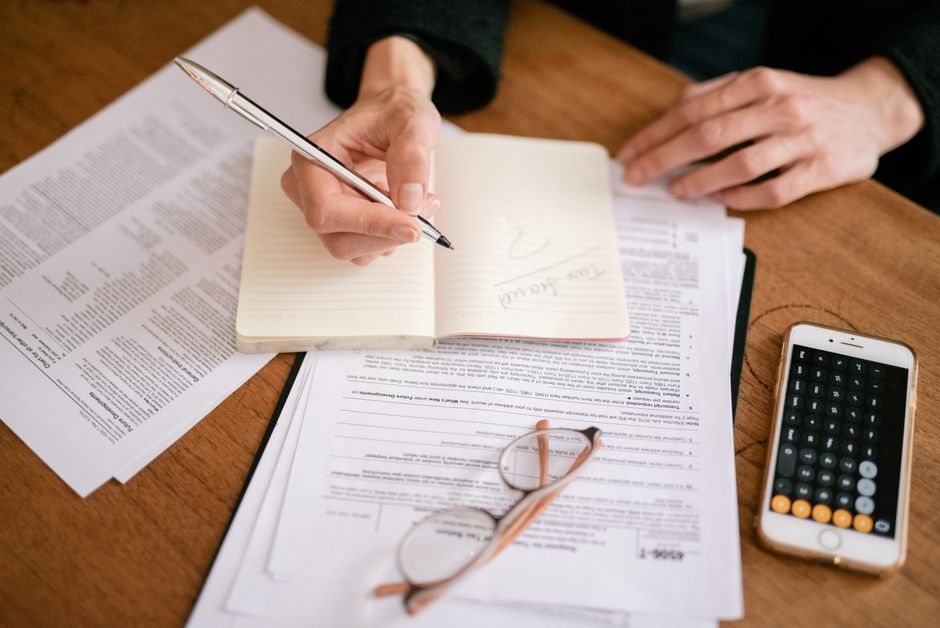 Employer reviewing a dismissal case with legal documents and calculator