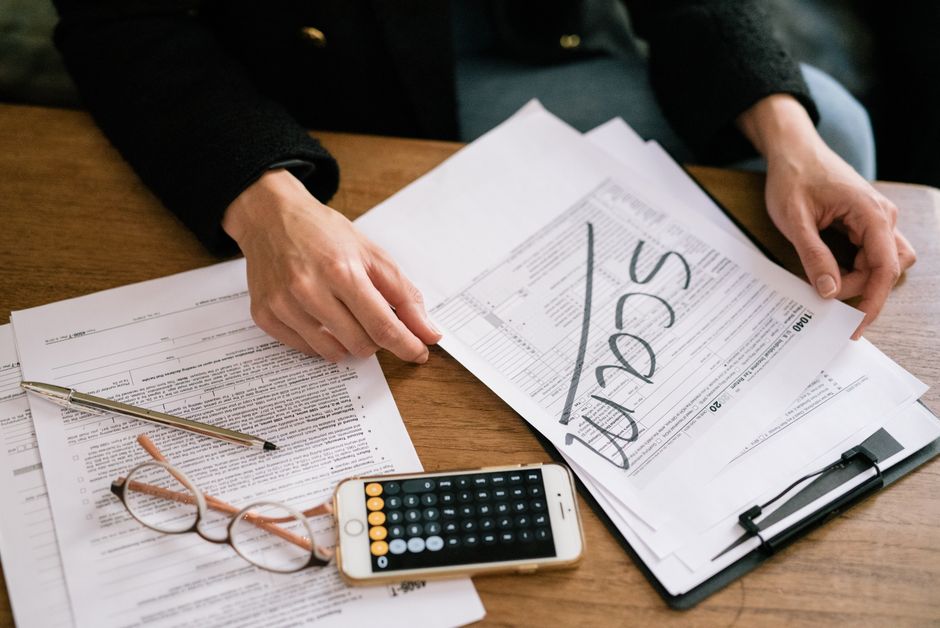 Calculator, tax forms and salary paperwork on a desk