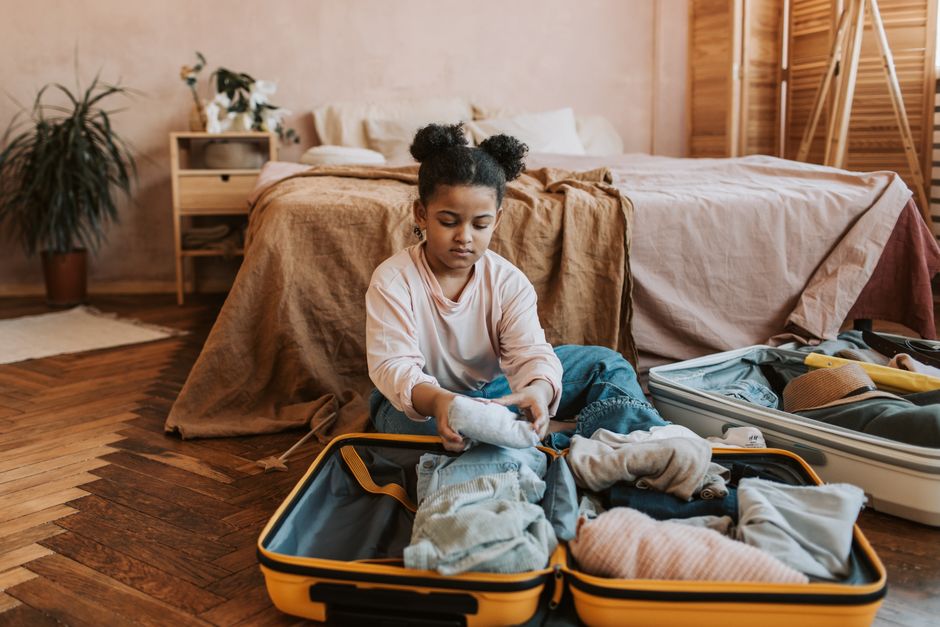 Young professional packing a suitcase for vacation