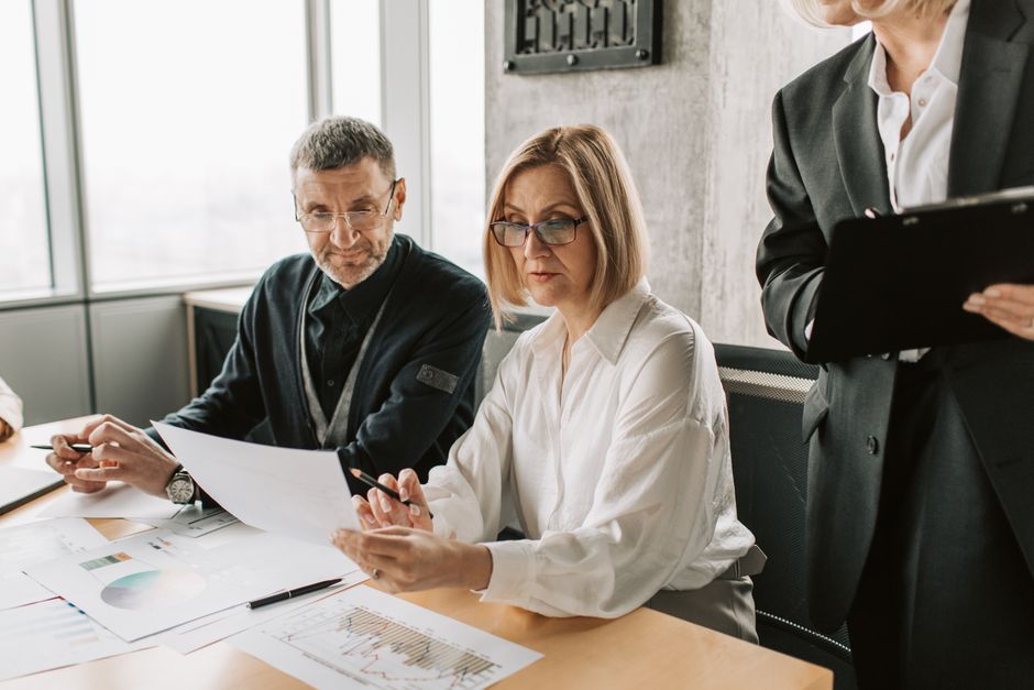 Team leader managing a meeting with charts and documents