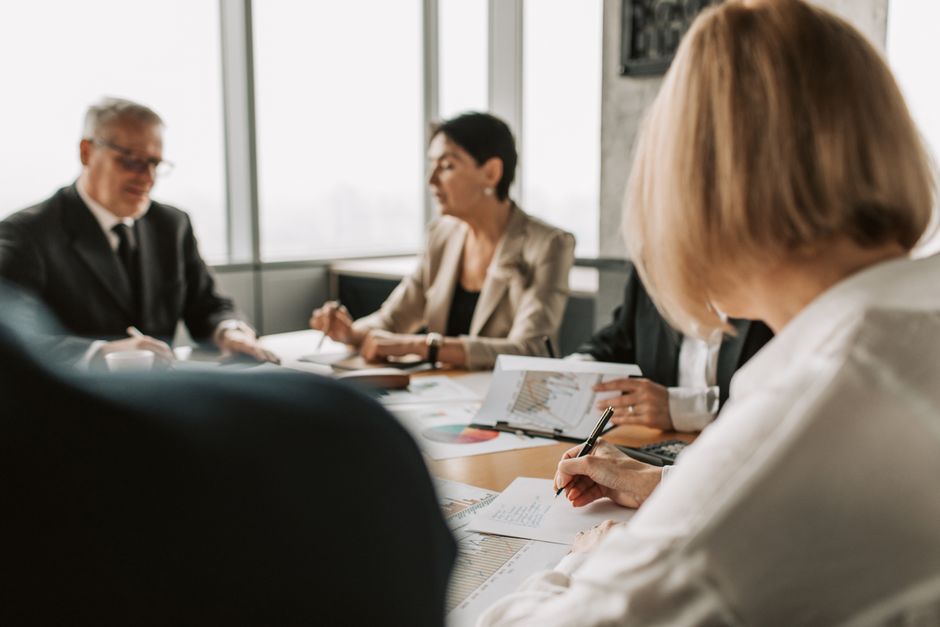 Team meeting in a corporate boardroom discussing strategy