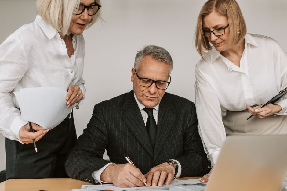 Senior professional reviewing unemployment benefits paperwork at a desk