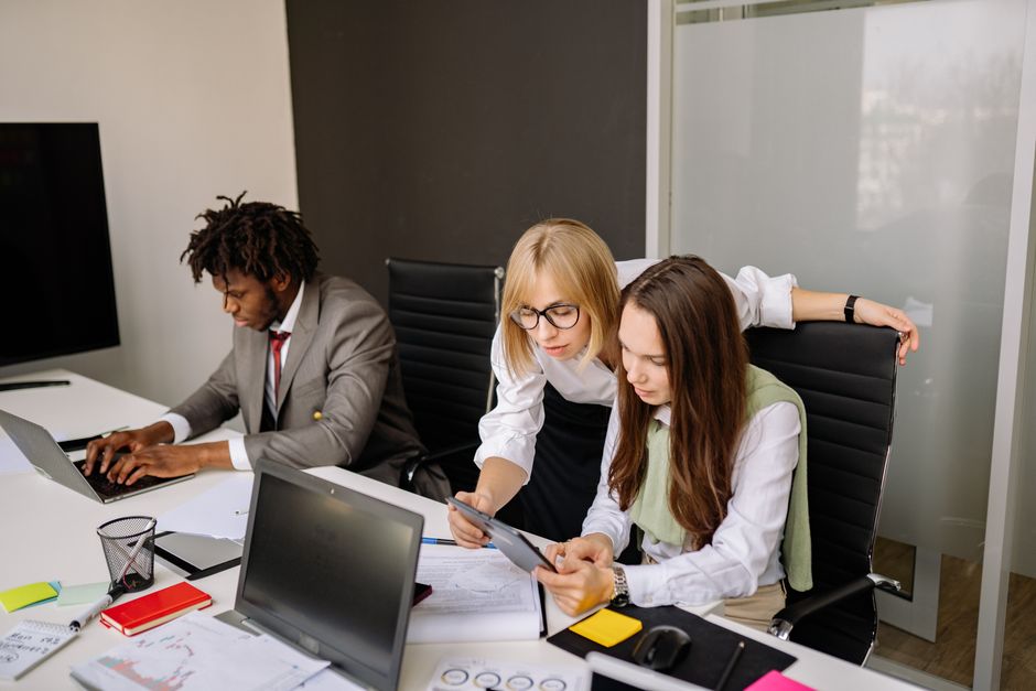 Digital project team collaborating in modern office