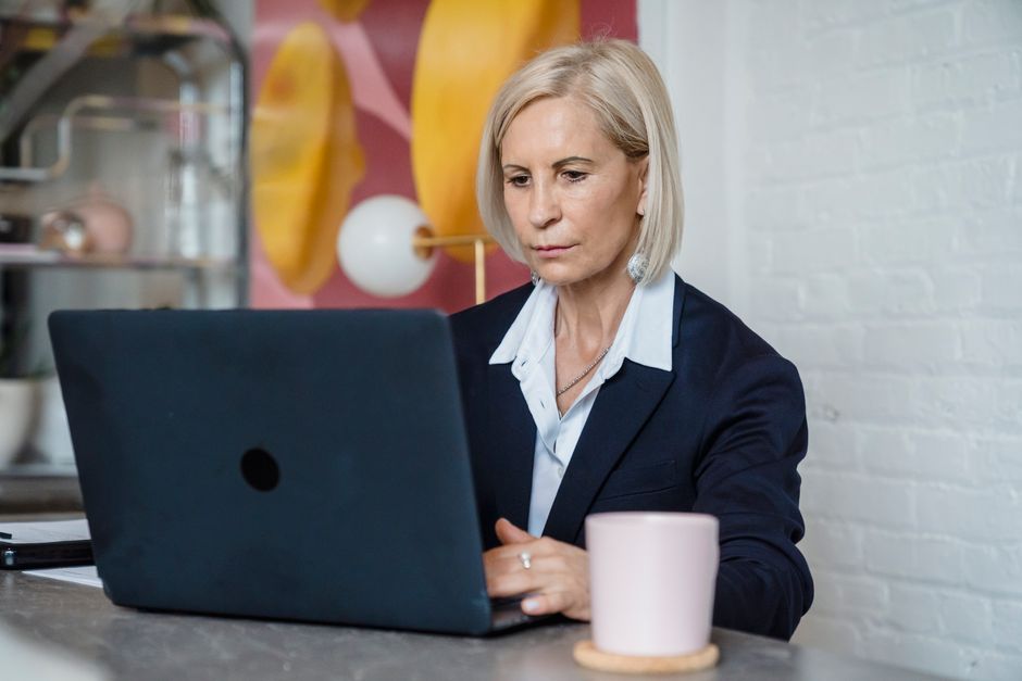 Mature job seeker using a laptop to search for employment opportunities