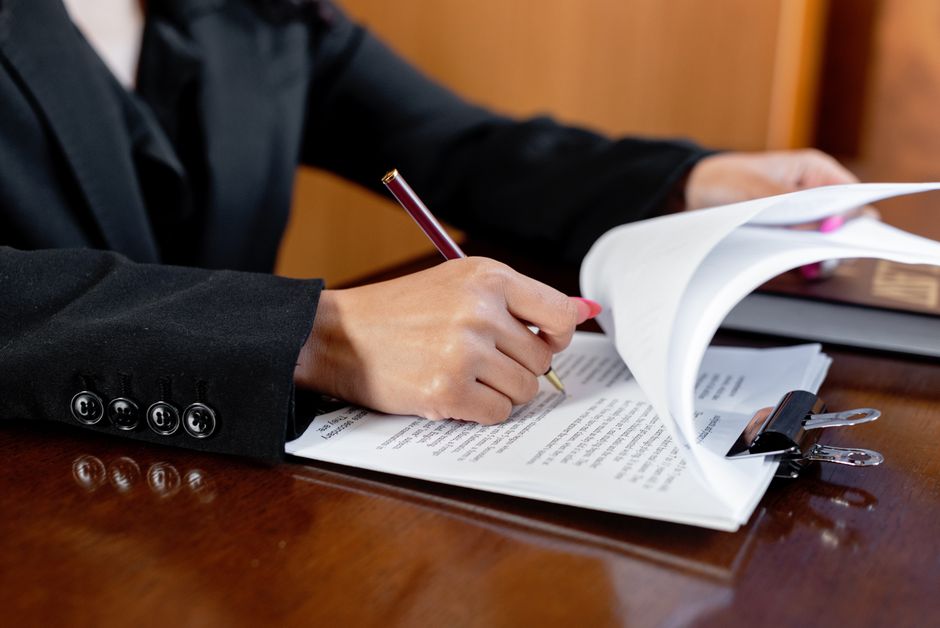 Lawyer reviewing employment contract and legal documents