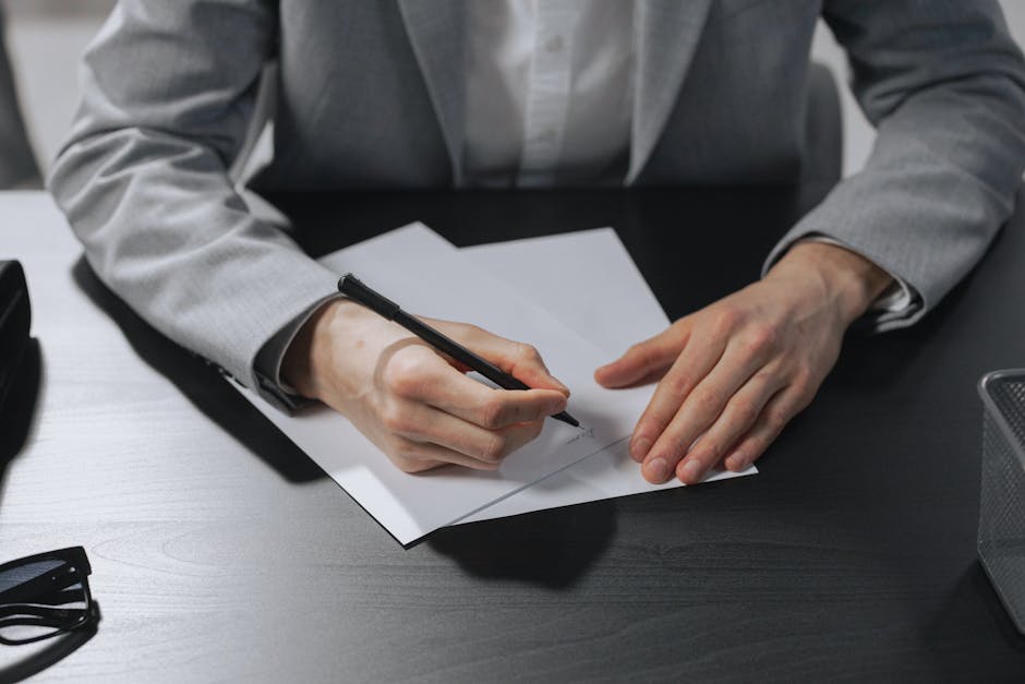 Employee writing a formal letter at a desk