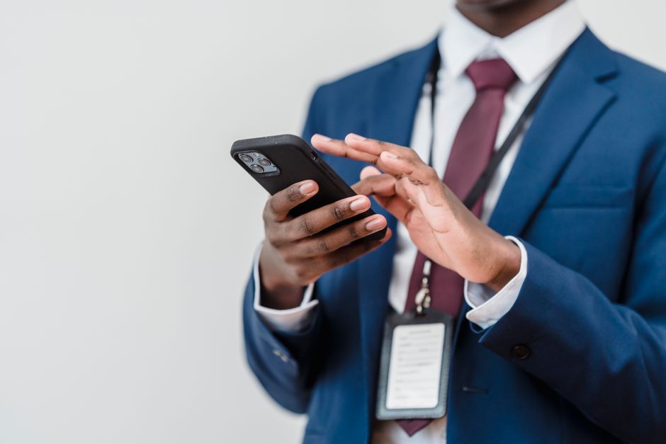 Person sending a message on a smartphone in a professional setting