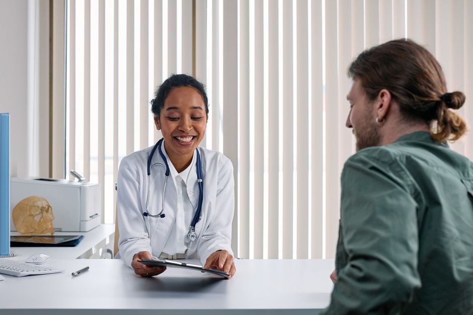 Incontinence urinaire d’effort : 6 repères AFU en 2025 A doctor and patient engaging in a positive consultation in a bright clinic setting.