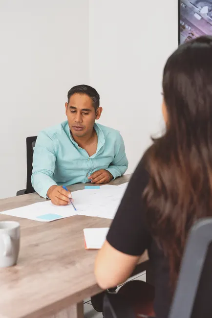 Man and woman discussing project plans together in a modern office.